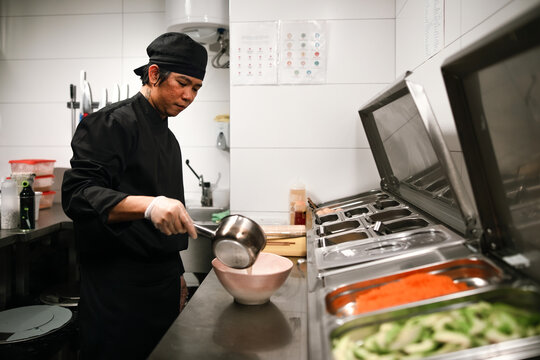 Chef Preparing Sauce in a Professional Restaurant Kitchen