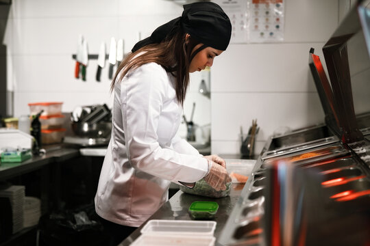 Female Chef Preparing Food in Professional Kitchen