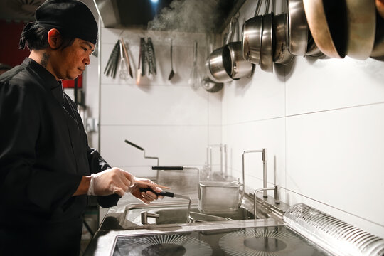 Chef Working in Professional Restaurant Kitchen With Steam