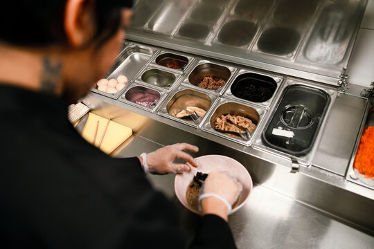 Chef Preparing Ramen Bowl at Restaurant Counter