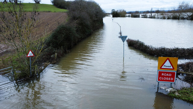 Aerial view of flooded road and warning sign  in the countryside