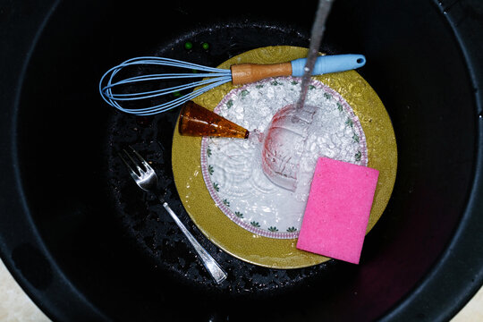 Kitchen items in a dishwashing sink 