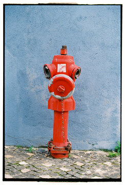 Red fire hydrant on cobblestone street