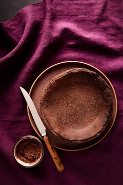 Chocolate Basque Cheesecake with Cocoa on Linen Tablecloth