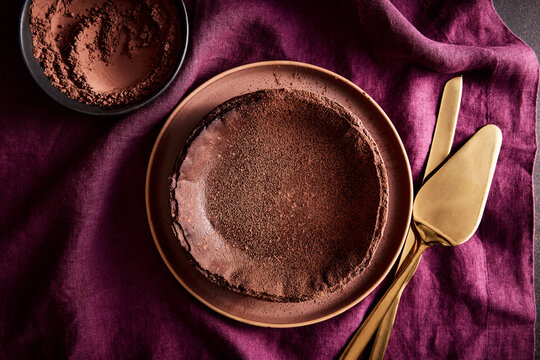 Chocolate Basque Cheesecake with Cocoa on a Linen Tablecloth 