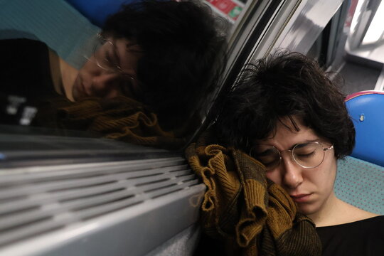 Candid portrait of a woman sleeping in the train
