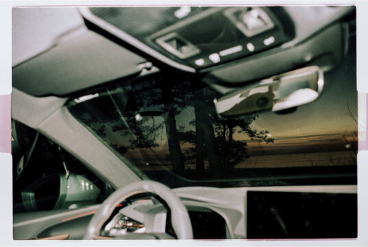 Car Interior with Sunset Reflected in Windshield