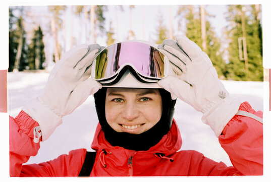 Smiling Skier Lifting Pink Goggles on Snowy Slope, Film Photo