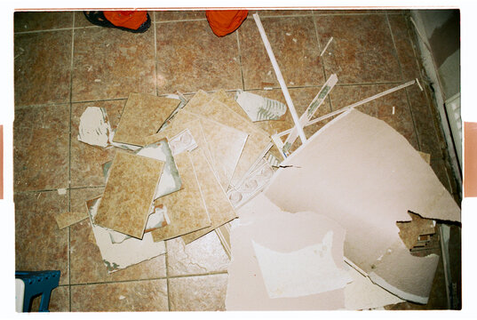 
Broken Tiles and Debris on Floor During Home Renovation