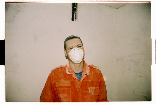 Construction Worker Wearing Protective Face Mask Indoors