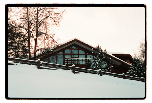 Modern Winter House on Snowy Hill at Sunset