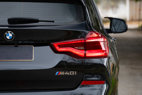 Black bmw x3 m40i tail light and model badge close up, Premium SUV rear design detail outdoors