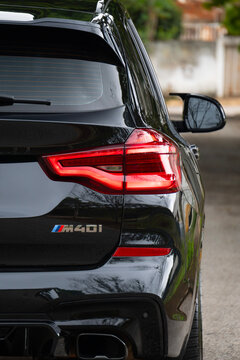 Black bmw x3 m40i tail light and model badge close up, Premium SUV rear design detail outdoors