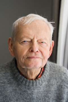 Portrait of an Senior Man in a Gray Sweater at Home