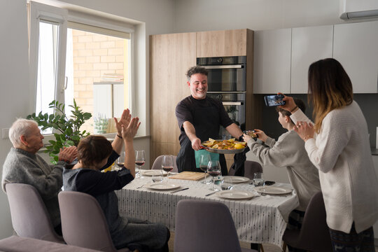 Family Gathers to Enjoy Paella