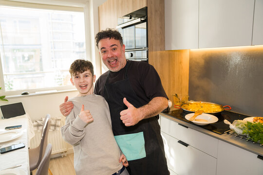 Man Having Fun With A Child While Cooking Together At Home