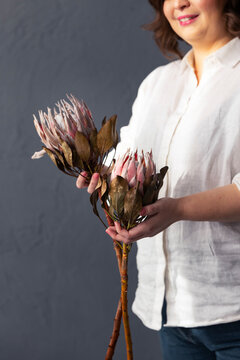 Woman Holding Protea Flowers 