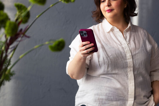 Woman Using Smartphone at a Flower Shop