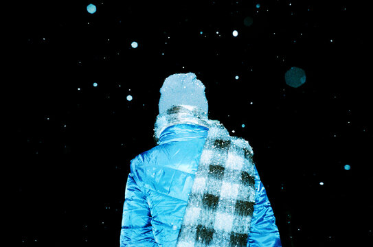 Person under night snowfall