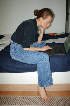 Person managing finances online, paying utility bills