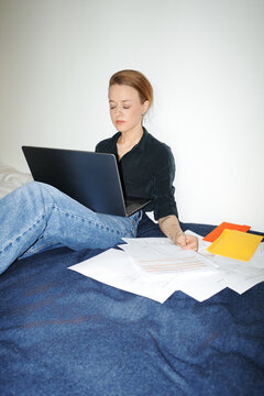 Person working on laptop managing finances at home