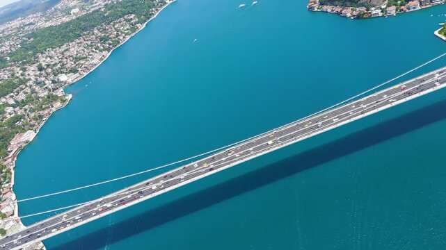 Istanbul, Turkey. Fatih Sultan Mehmet Bridge is a suspension bridge across the Bosphorus Strait, between Europe and Asia. Sunny day. Aerial View, MasterShots, Fly Forward - Roll