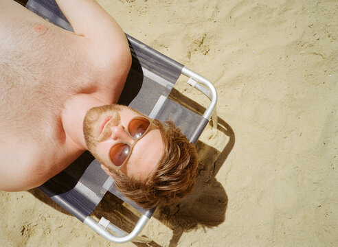 Man Relaxes on a Lounge Chair 