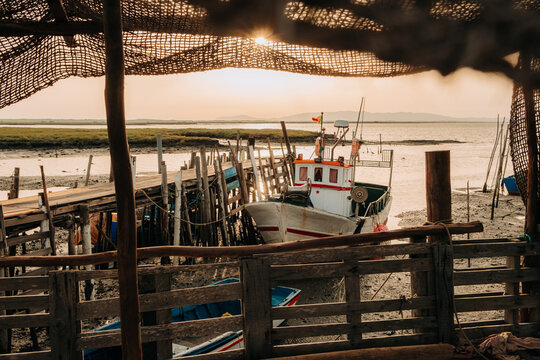 Fishing Boat at Wooden Dock During Golden Hour
