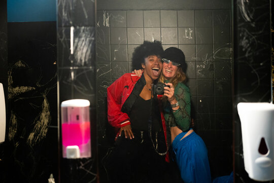 Two women in the bathroom of a party 