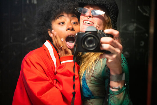 Two women in the bathroom of a party 