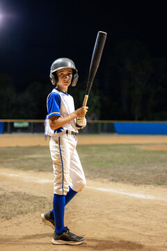 Young Baseball batter looking at camera