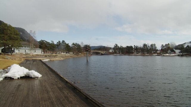 Panning View Nisser Lake Treungen Norway, Scenic Winter Landscape with Wooden Pier and Nordic Nature