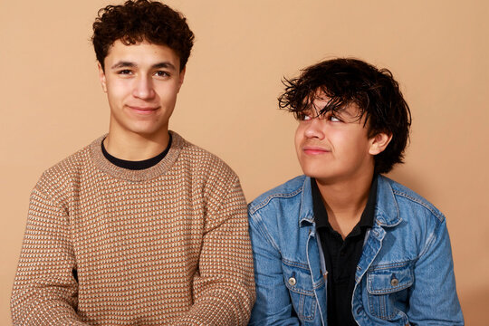 Two Young Men Sit Together