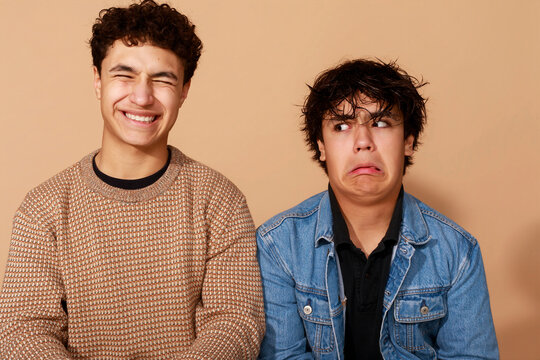 Two Friends Share Smiles and Silly Faces in a Studio Setting