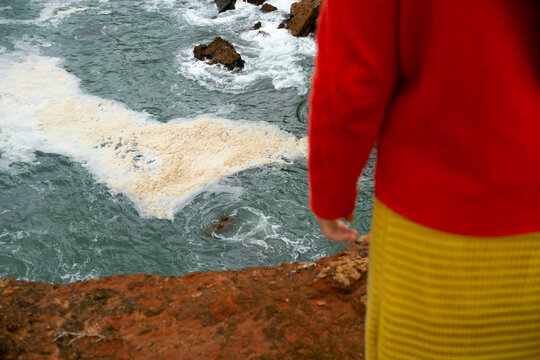 A colourful woman by the sea