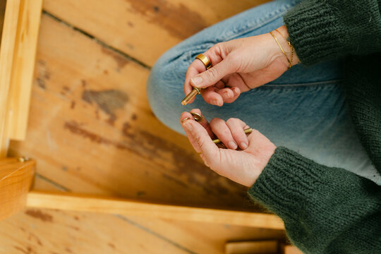 hands of woman with smart ring building a bed 
