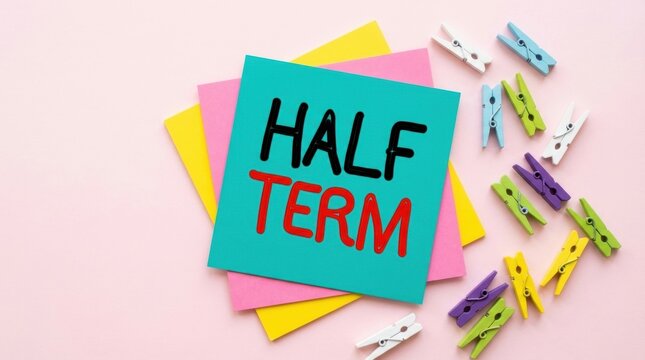 Colorful sticky notes with 'half term' and clothespins on pastel background for school break concept