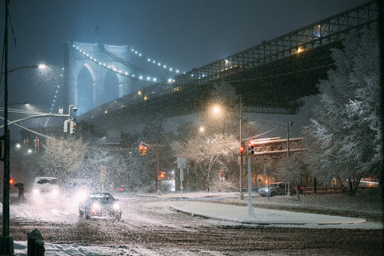Snowfall at Brooklyn Bridge Intersection at Night
