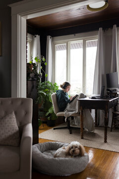 Seated Girl listening to music, and working. 