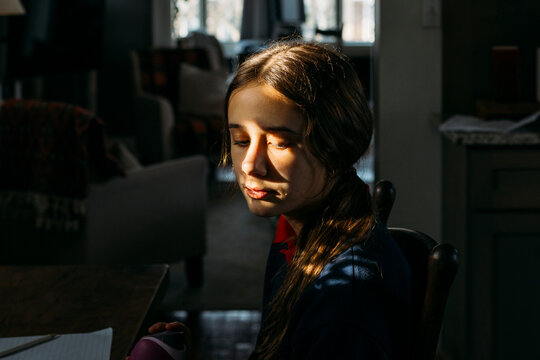 Girl portrait sitting in the shadows.
