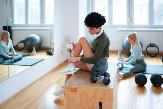 Women preparing for workout in gym space