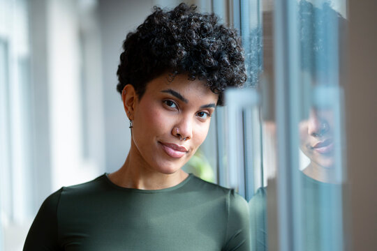 Portrait of a person by a window in a room