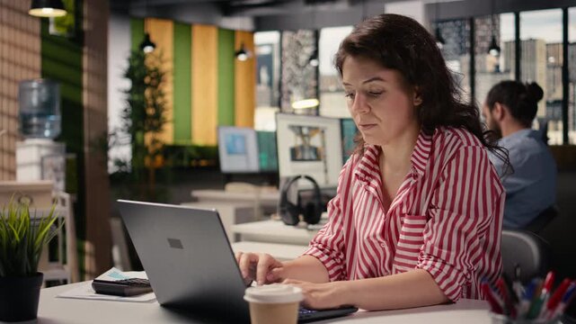 Female worker, woman at desk with laptop, working in smart office corporation, providing business administration for new strategy and project growth. Staff ensuring productivity startup.