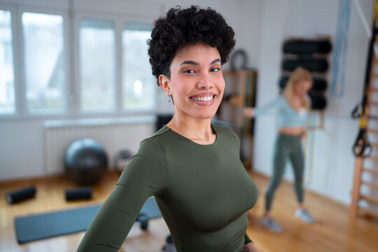 Woman smiles in fitness studio during workout time