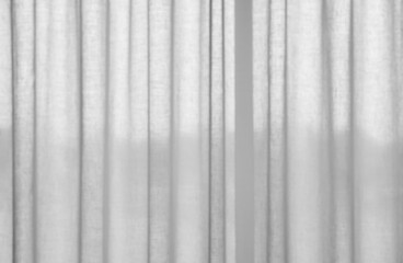 Obraz premium A minimalist background of soft white linen curtains with vertical folds, diffused light creating a bright, airy, and tranquil atmosphere for interior design concepts