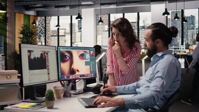 Two photo editors colleagues using color grading on retouching software, graphic design commercial materials for advertising agency content. Image selection on computer in post production.