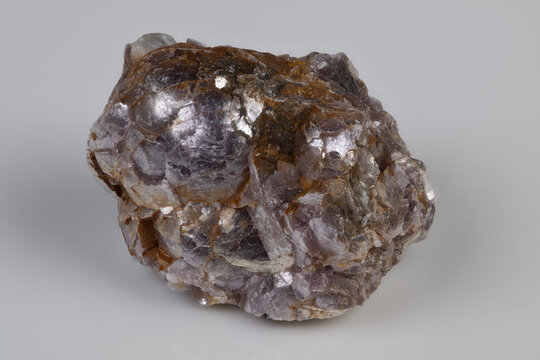 Exquisite lepidolite specimen with sparkling mica on neutral backdrop. Carefully curated lepidolite offering tactile sensation and detailed mineralogical insight