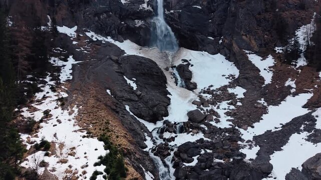 Aerial: Engstligen Falls near Adelboden during the day, second highest fall in Switzerland, crane up drone shot