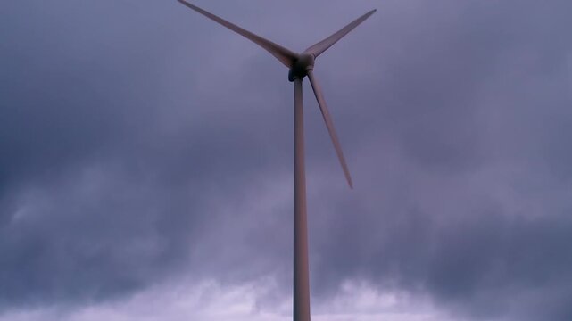 Wind turbine generating sustainable power in the Serra da Boneca wind farm, utilizing renewable resources from a powerful stormy sky, emphasizing environmental responsibility and green technology