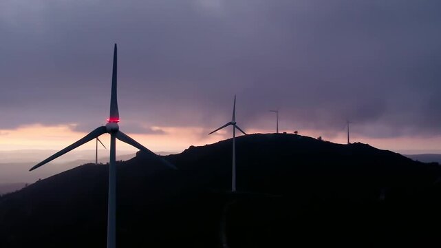 Wind farm Serra da Boneca in Portugal generating clean energy, with wind turbines silhouetted against a dramatic sunset sky at dusk, symbolizing sustainability and eco friendly power production